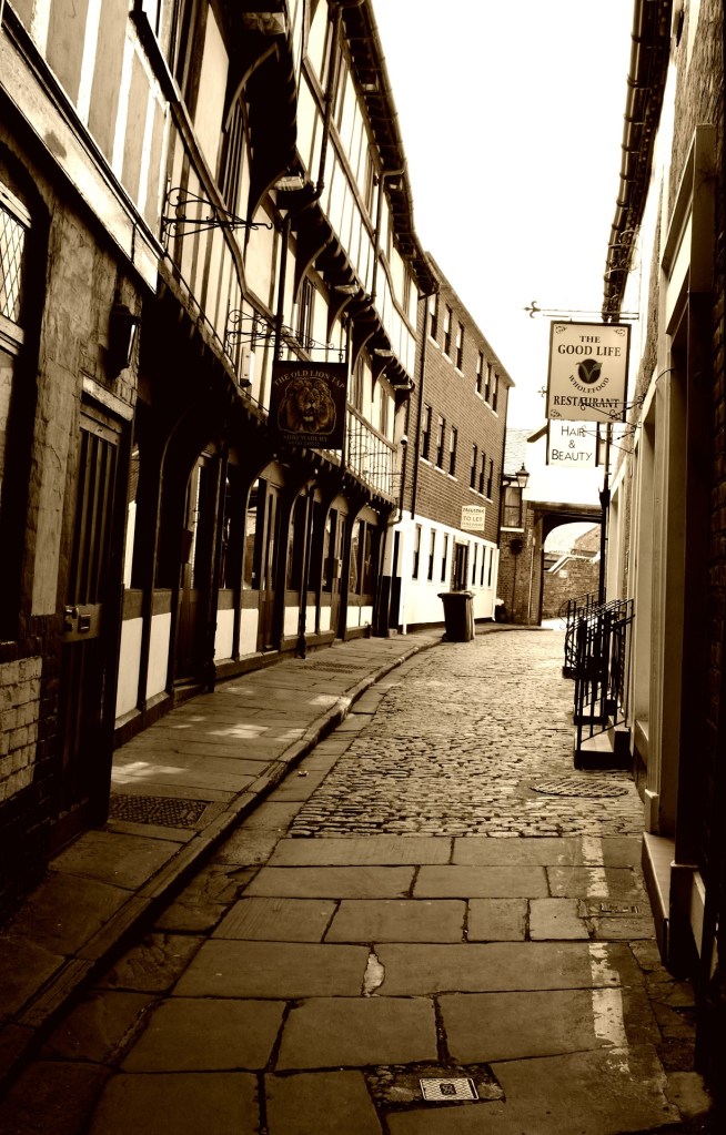 Black and white stock image of a narrow street in Shrewsbury, Shropshire